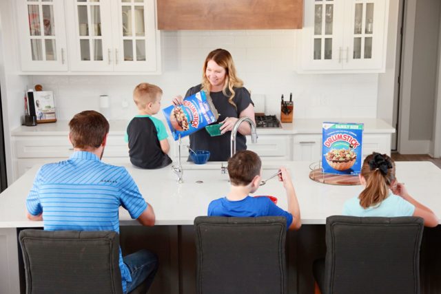 mom pouring cereal for family