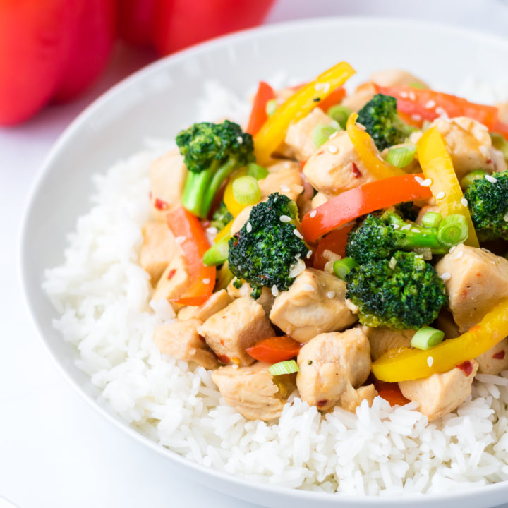 Chicken, veggies and rice on a white plate