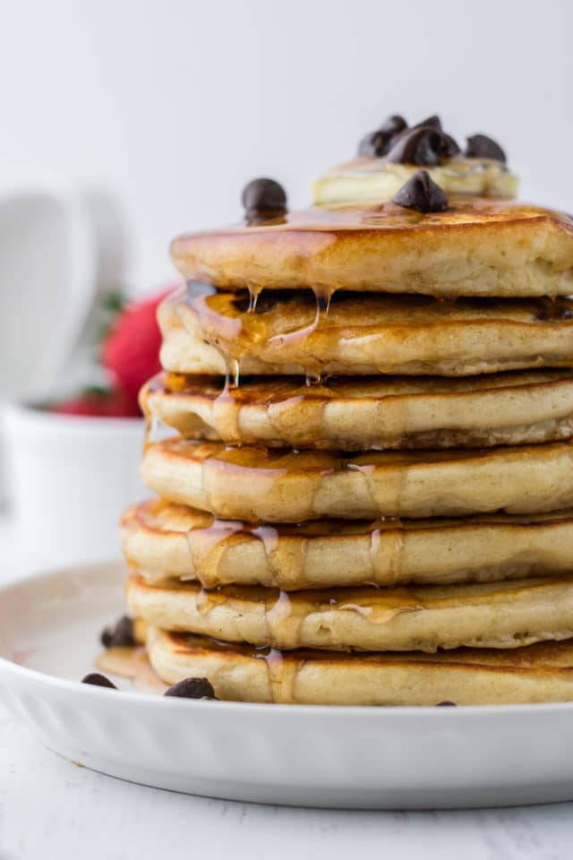 close up of stacked pancakes with syrup running down them