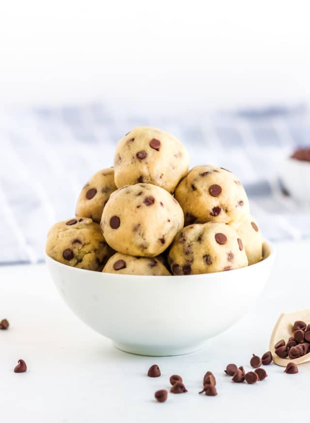 cookie dough rolled into balls in a white bowl