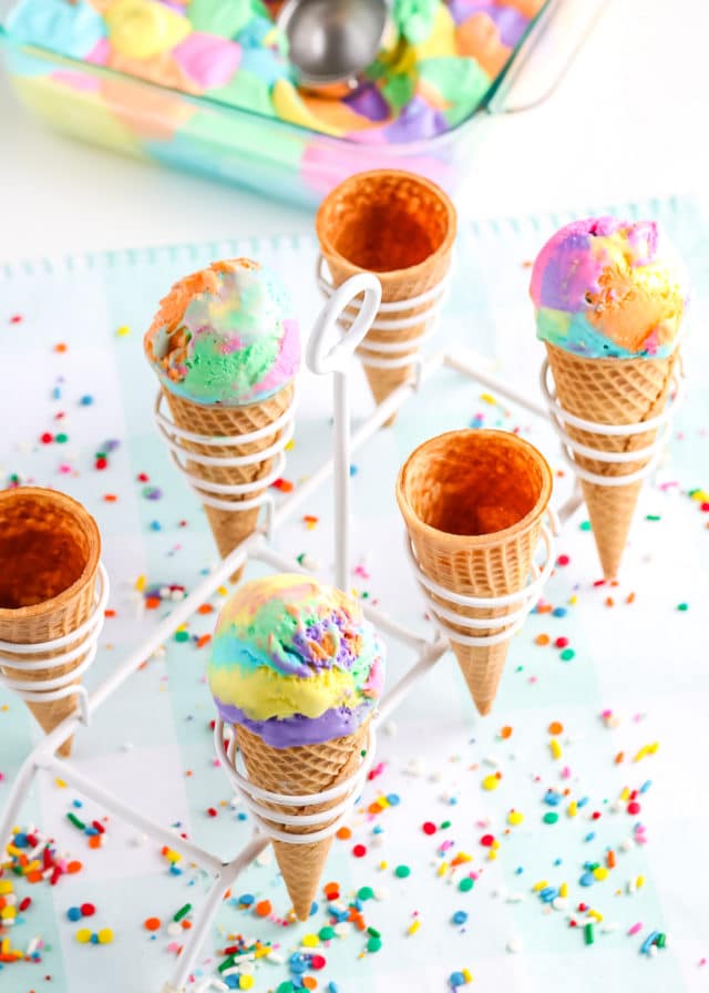 ice cream in cones with a stand with confetti around it