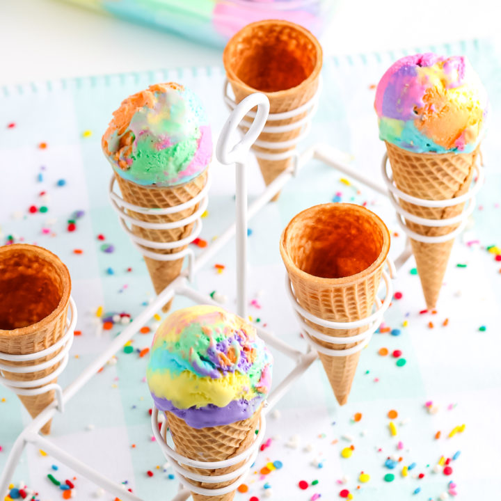 ice cream in cones with a stand with confetti around it