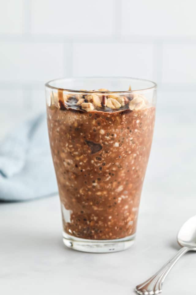 Oats and chocolate in a glass jar with spoon