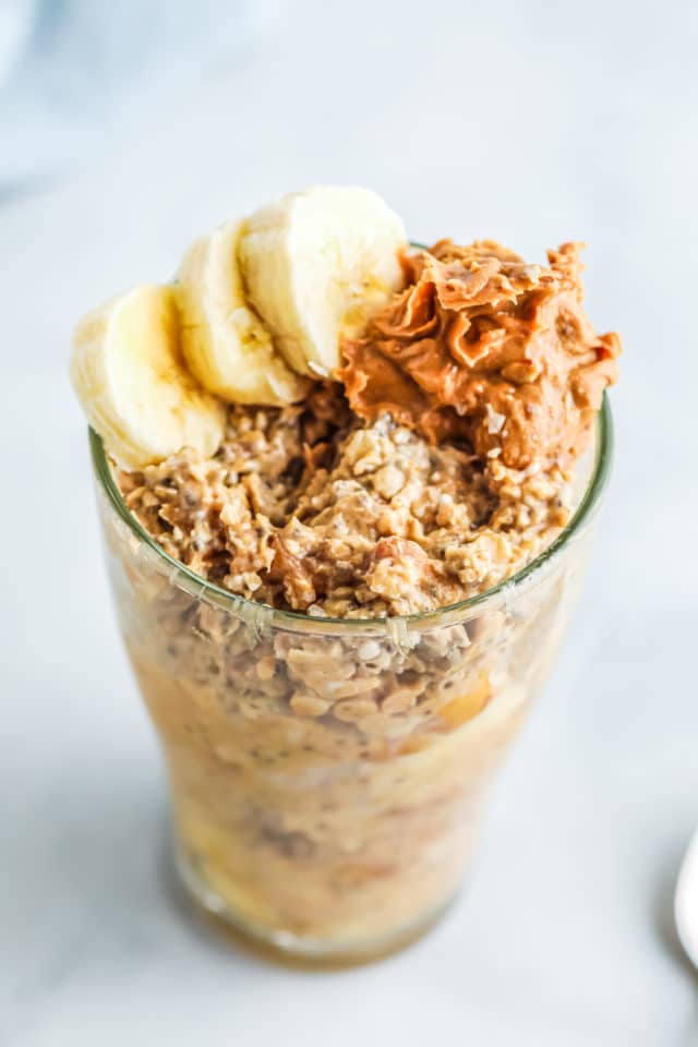 oats in jar with peanut butter and banana on top