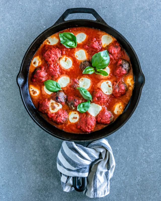 cheese, basil and meatballs in a skillet