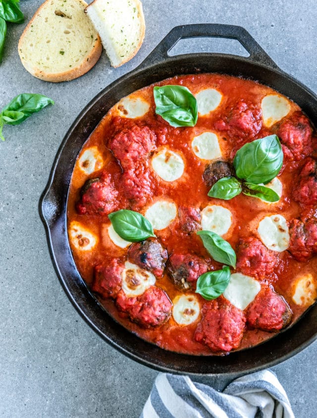 overhead shot of sauce and meatballs in a skillet