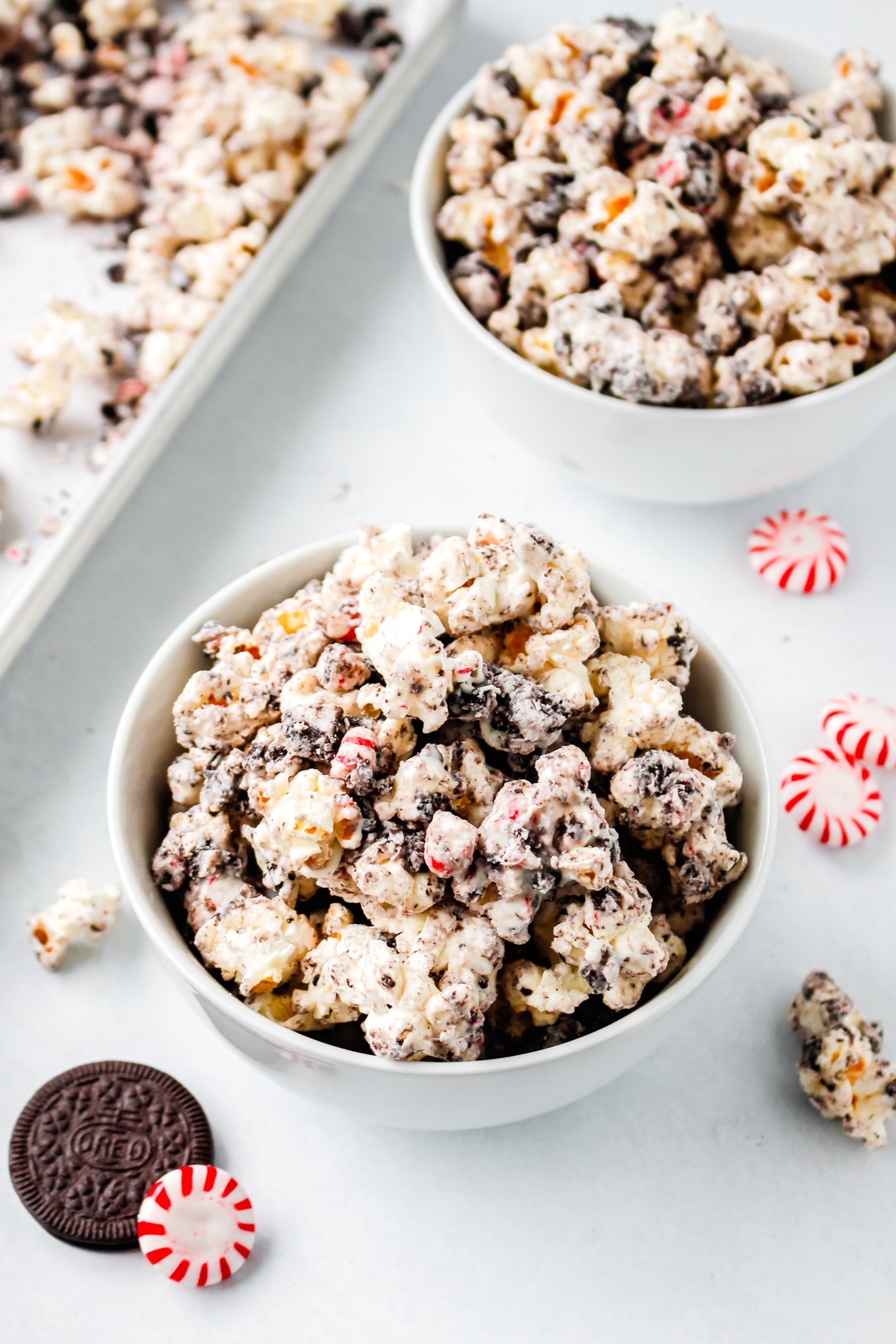 two bowls of popcorn topped with chocolate and cookies